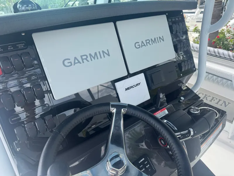 Slide: The Image of 2026 Blackfin 302 CC boat dashboard with Garmin displays and Mercury controls. - 26