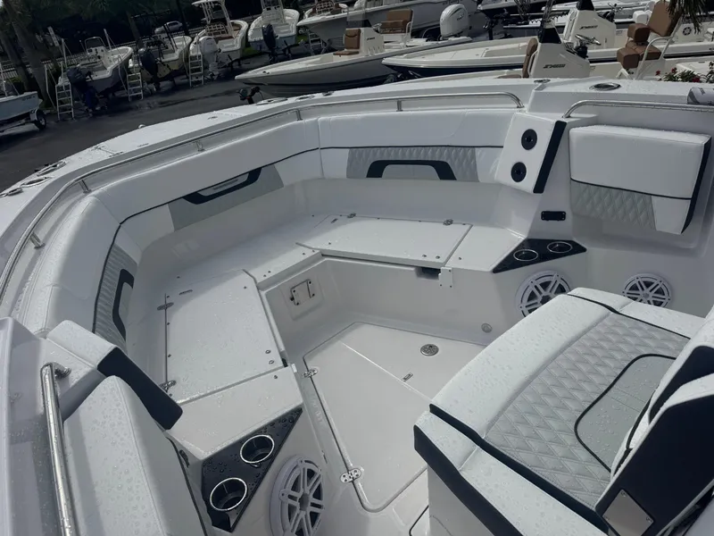 Slide: The Image of 2026 Blackfin 302 CC boat interior with seating, cup holders, and speakers. - 28