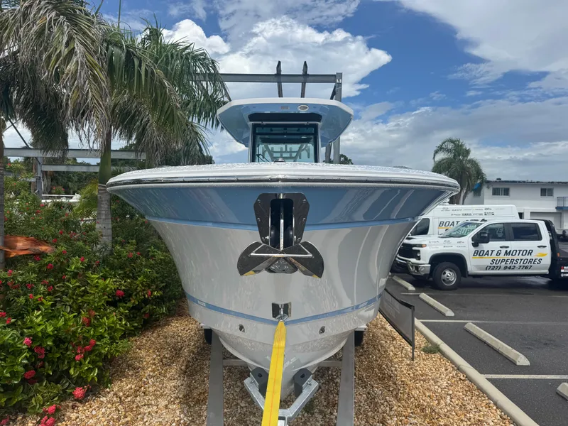 Slide: The Image of 2026 Blackfin 302 CC boat displayed outdoors with palm trees and vehicles in the background. - 3