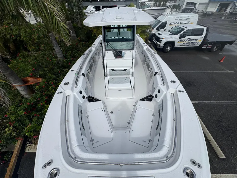Slide: The Image of 2026 Blackfin 302 CC boat with spacious deck and modern design in a marina setting. - 30