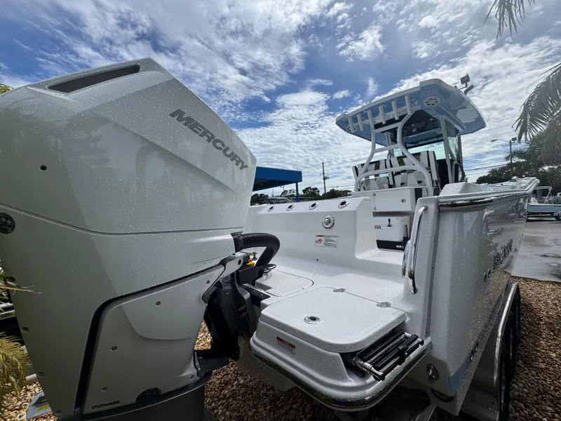 Slide: The Image of 2026 Blackfin 302 CC boat with Mercury engine under a cloudy sky. - 5