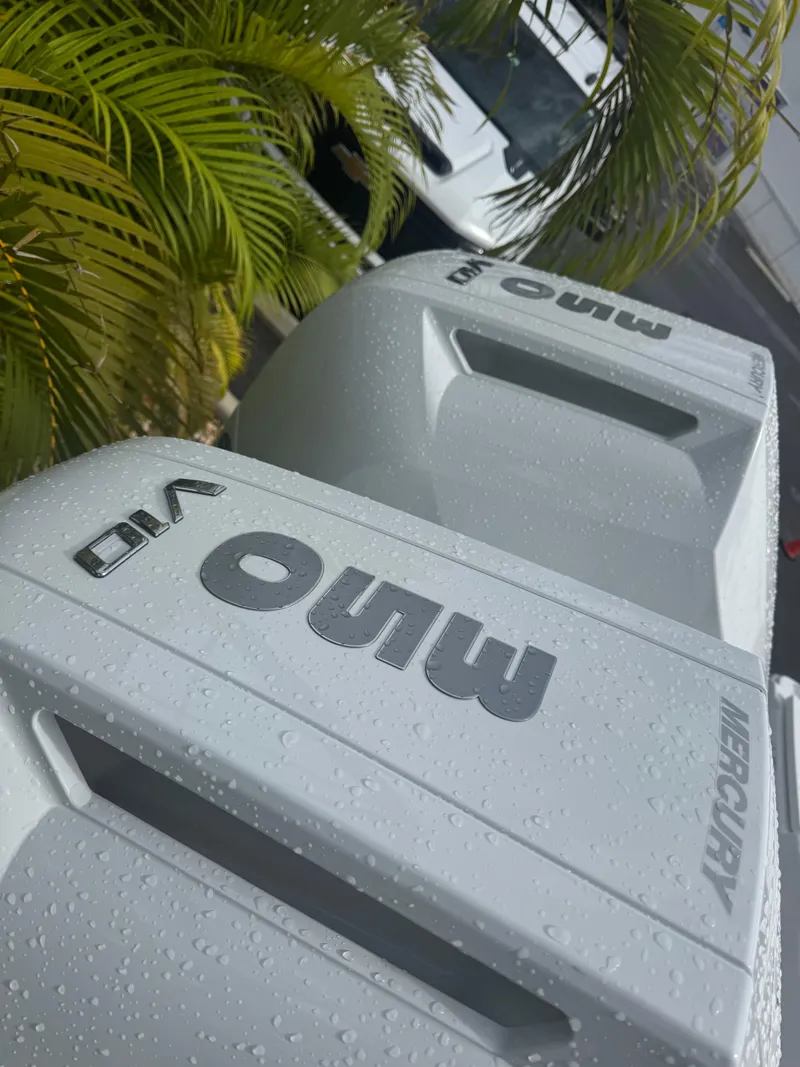 Slide: The Image of Close-up of Mercury outboard engines on a 2026 Blackfin 302 CC boat, with water droplets. - 7