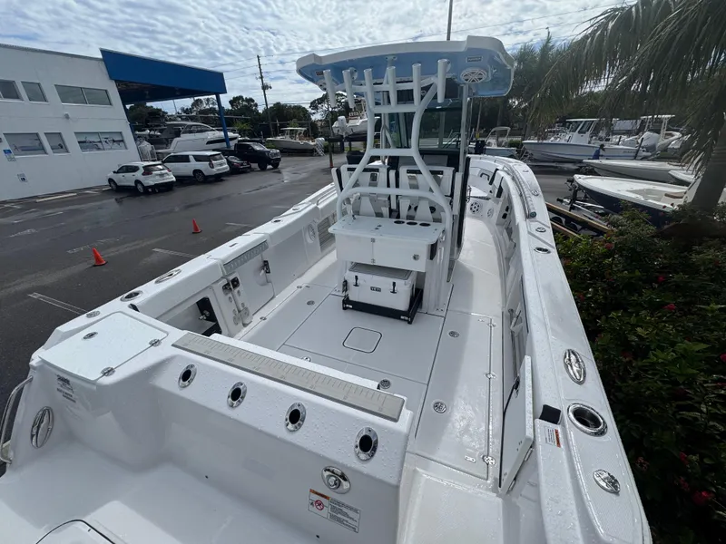Slide: The Image of 2026 Blackfin 302 CC boat docked, showcasing spacious deck and modern design. - 9