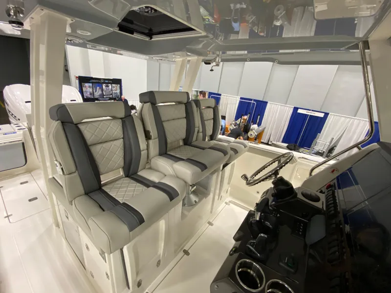 Slide: The Image of 2024 Pursuit S 358 boat interior with luxurious seating and modern dashboard controls. - 10