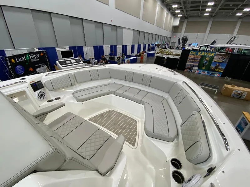 Slide: The Image of 2024 Pursuit S 358 boat interior with spacious seating at a boat show. - 13