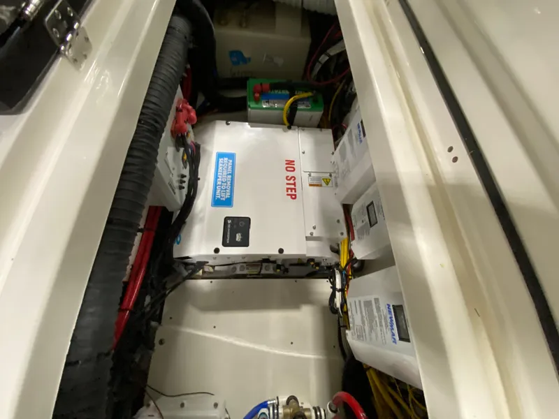 Slide: The Image of 2024 Pursuit S 358 engine compartment with electrical components and wiring. - 19