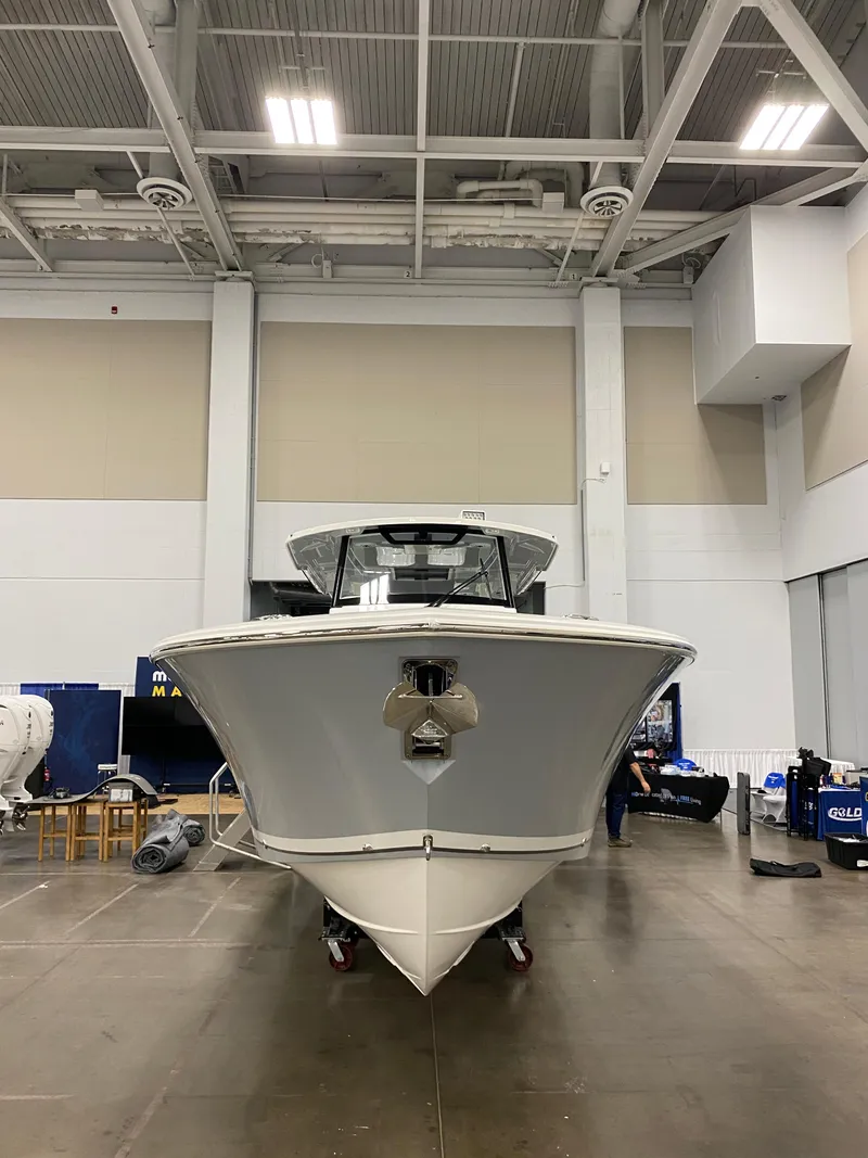 Slide: The Image of 2024 Pursuit S 358 boat displayed indoors, showcasing sleek design and modern features. - 2