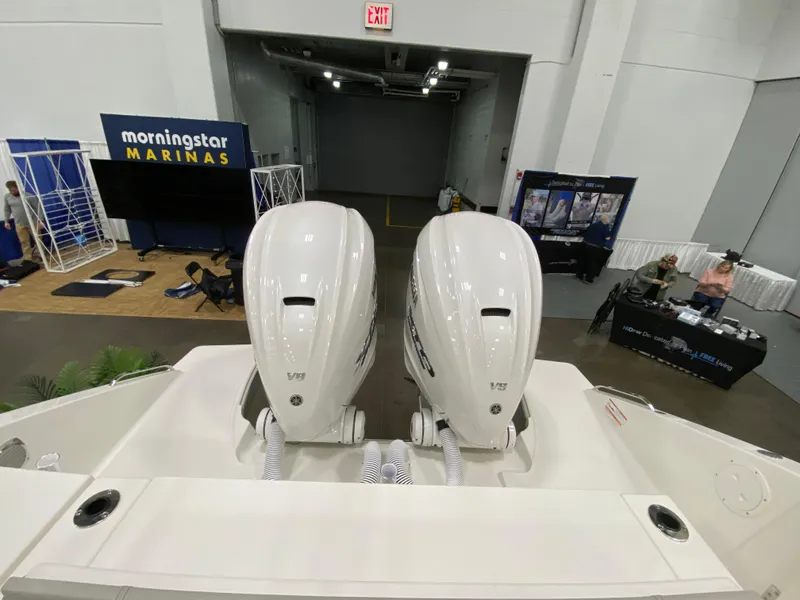 Slide: The Image of 2024 Pursuit S 358 boat with dual outboard engines at a marina exhibition. - 20
