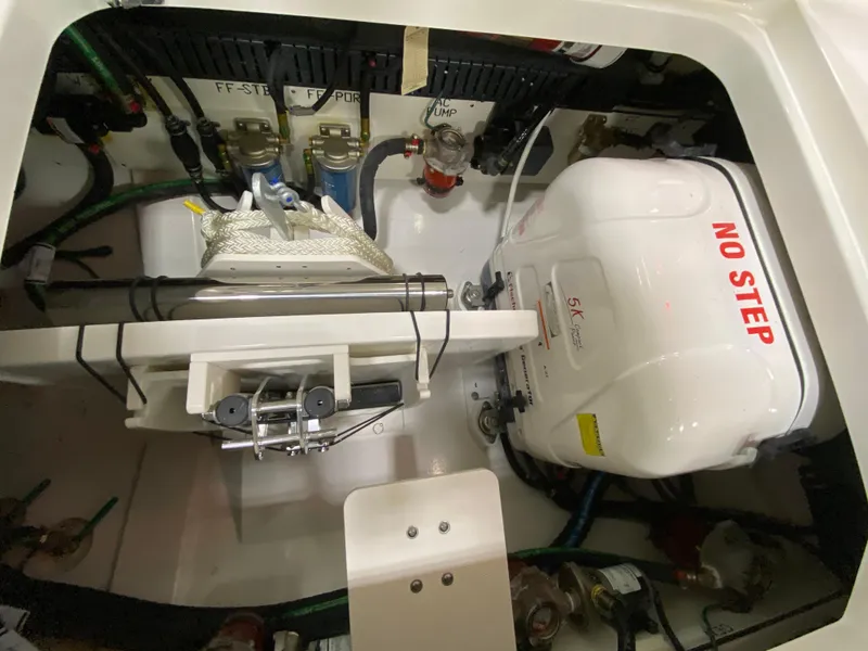 Slide: The Image of Engine compartment of 2024 Pursuit S 358 boat with "No Step" warning label. - 21