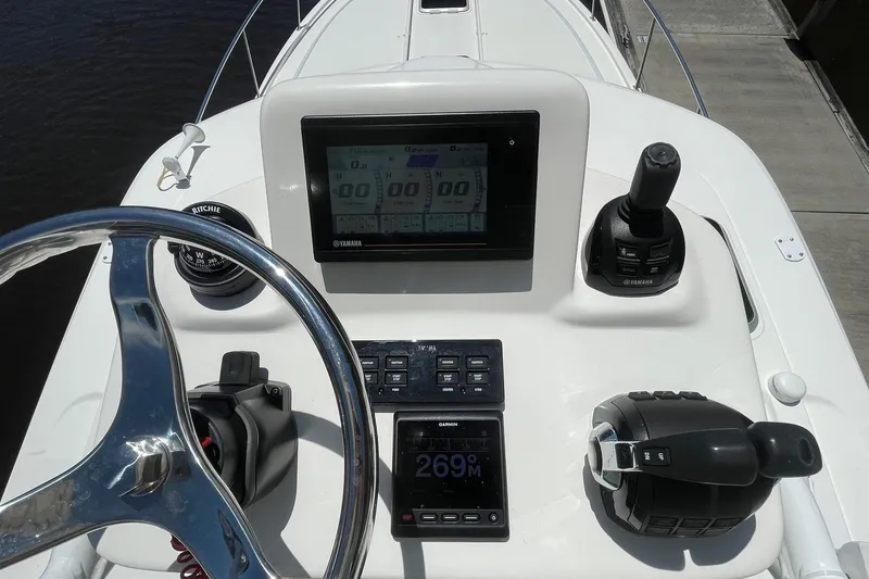 Slide: The Image of Control panel of 2021 Pursuit OS 385 Offshore boat with steering wheel and navigation display. - 10