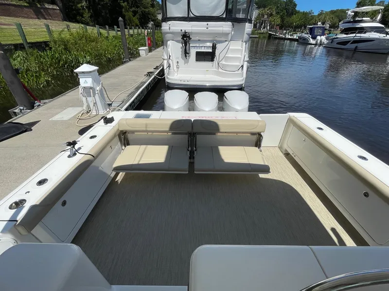 Slide: The Image of 2021 Pursuit OS 385 Offshore boat docked, featuring spacious seating and modern design. - 12