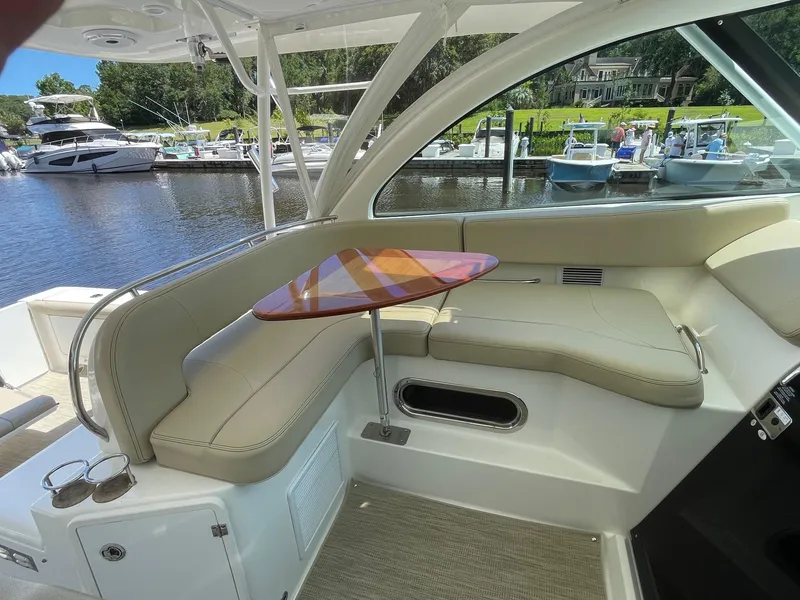 Slide: The Image of Luxurious 2021 Pursuit OS 385 Offshore boat interior with elegant seating and table. - 14
