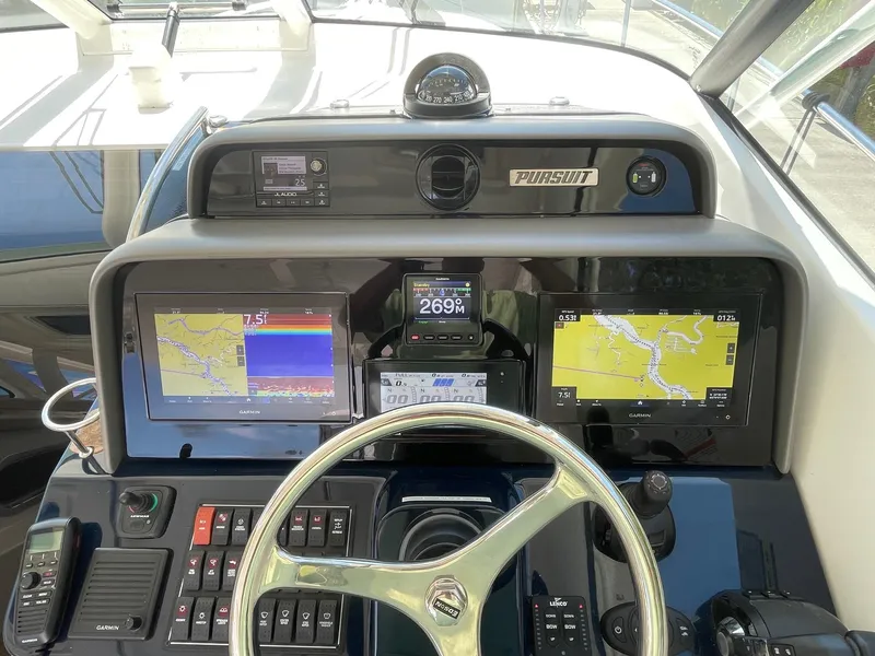 Slide: The Image of 2021 Pursuit OS 385 Offshore helm with Garmin navigation displays and controls. - 17