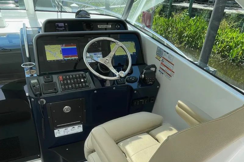 Slide: The Image of Helm of 2021 Pursuit OS 385 Offshore boat with navigation screens and controls. - 18