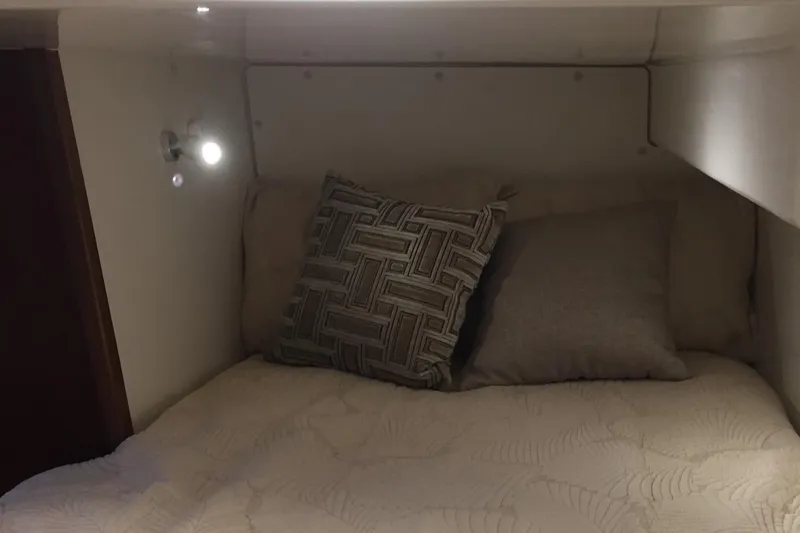 Slide: The Image of Cozy cabin interior of 2021 Pursuit OS 385 Offshore with pillows and soft lighting. - 20