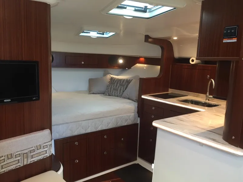Slide: The Image of Luxurious interior of 2021 Pursuit OS 385 Offshore boat with bed and kitchenette. - 21