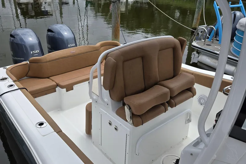 Slide: The Image of 2022 Sea Hunt Ultra 265 SE boat interior with tan seating and dual Yamaha 150 engines. - 11