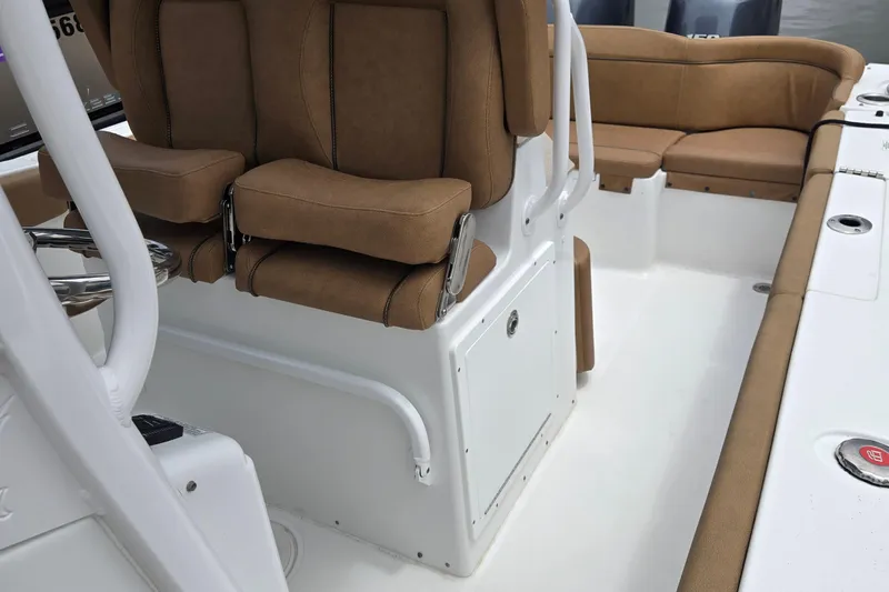 Slide: The Image of 2022 Sea Hunt Ultra 265 SE boat interior with tan seating and white deck. - 13