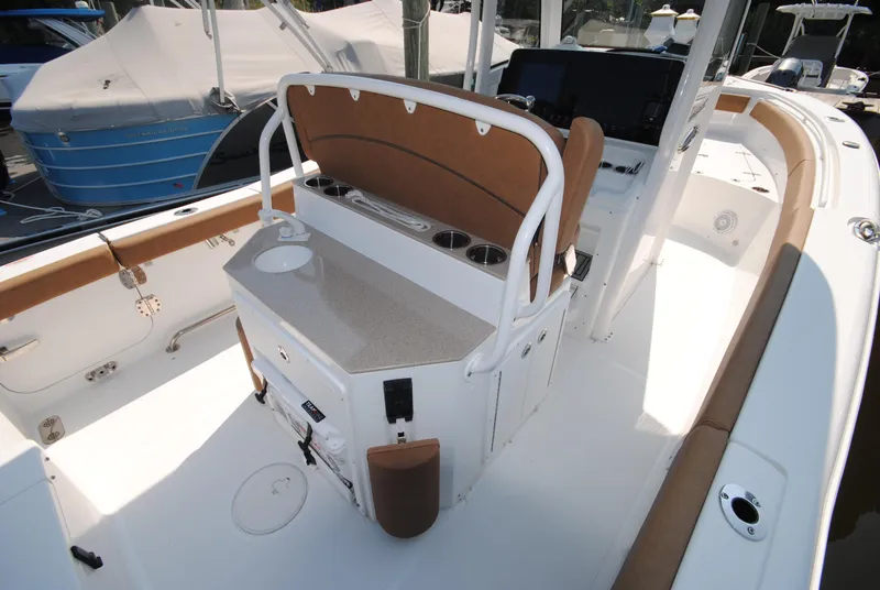 Slide: The Image of 2022 Sea Hunt Ultra 265 SE boat interior with seating and console. - 15