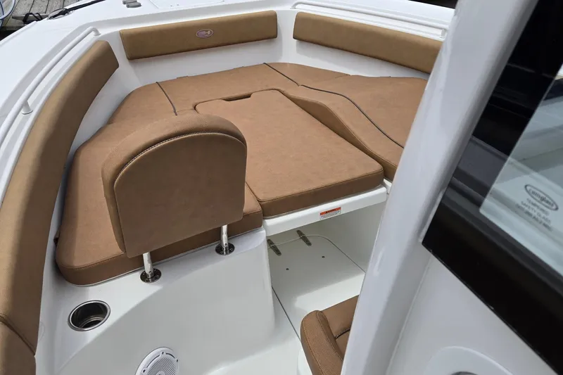 Slide: The Image of 2022 Sea Hunt Ultra 265 SE boat interior with tan cushioned seating. - 16