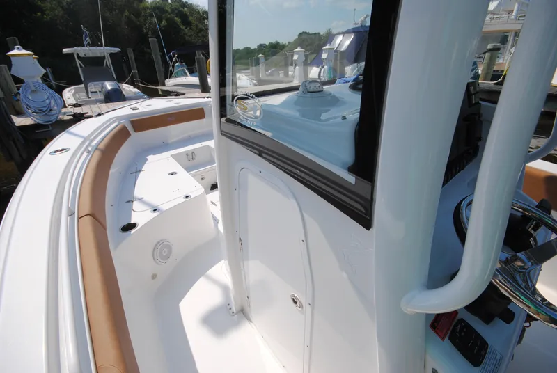Slide: The Image of 2022 Sea Hunt Ultra 265 SE boat interior with seating and control panel. - 18