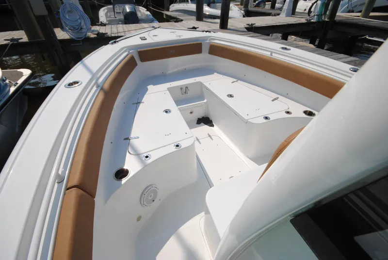 Slide: The Image of 2022 Sea Hunt Ultra 265 SE boat interior with cushioned seating and storage compartments. - 19