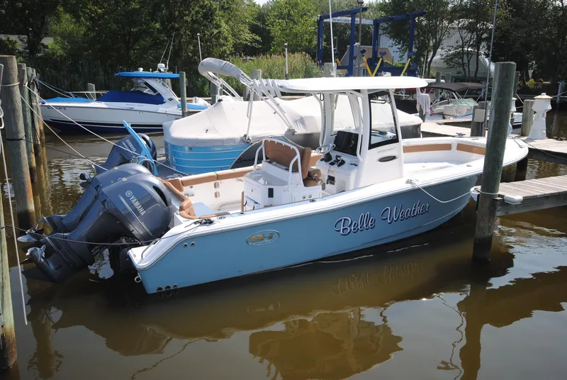 Slide: The Image of 2022 Sea Hunt Ultra 265 SE boat docked with twin Yamaha engines. - 6