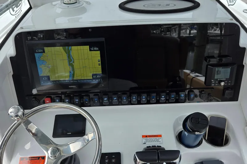 Slide: The Image of 2022 Sea Hunt Ultra 265 SE dashboard with navigation system and controls. - 9
