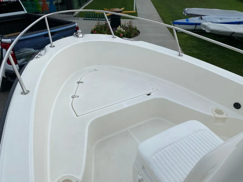 Slide: The Image of 2021 Boston Whaler 190 Outrage boat interior with seating and storage compartment. - 12