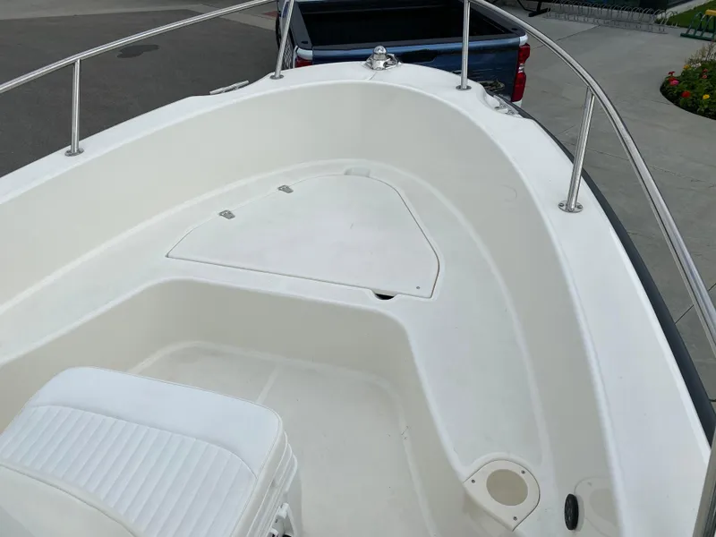 Slide: The Image of 2021 Boston Whaler 190 Outrage boat interior with seating and storage. - 13
