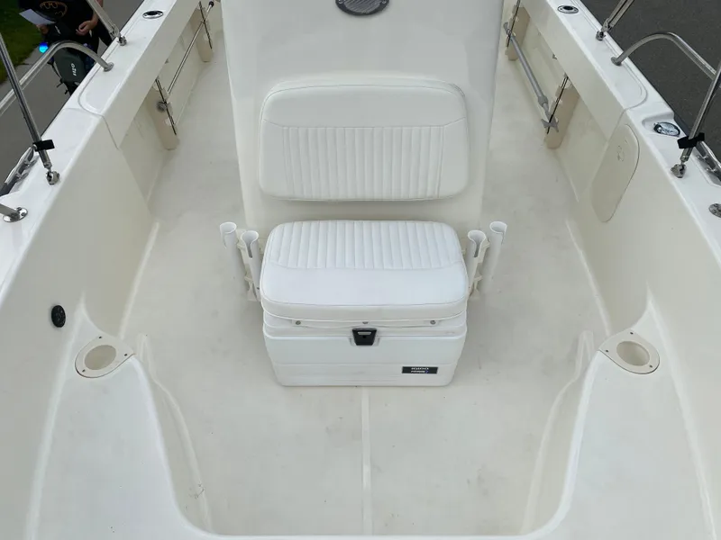 Slide: The Image of 2021 Boston Whaler 190 Outrage boat interior with white seating and storage. - 15