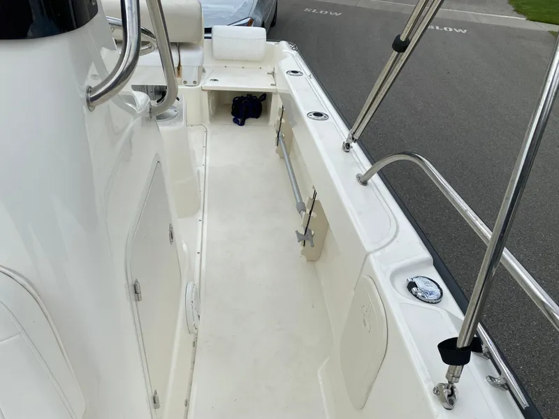 Slide: The Image of 2021 Boston Whaler 190 Outrage boat interior with seating and stainless steel railings. - 17