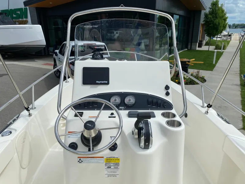Slide: The Image of Boston Whaler 190 Outrage 2021 boat console with steering wheel and Raymarine display. - 18