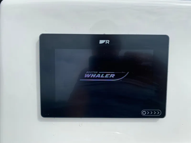 Slide: The Image of Touchscreen display on 2021 Boston Whaler 190 Outrage boat, showing brand logo. - 20