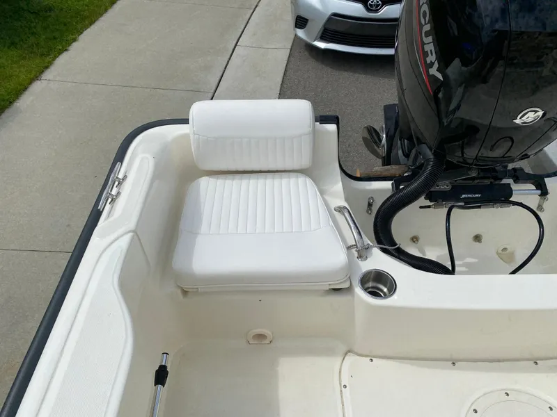 Slide: The Image of 2021 Boston Whaler 190 Outrage boat interior with white seating and Mercury engine. - 28