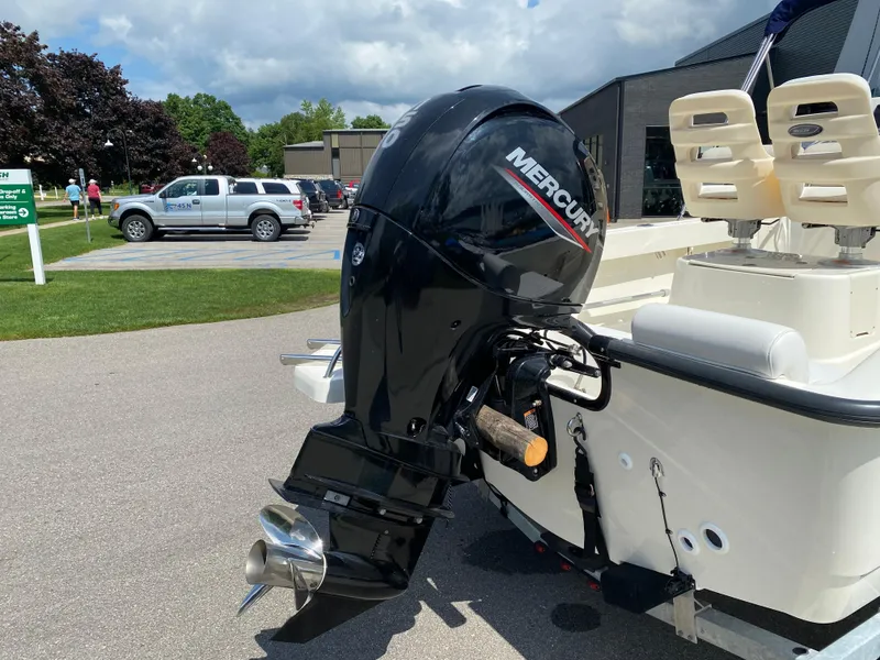 Slide: The Image of 2021 Boston Whaler 190 Outrage with Mercury outboard motor, parked outdoors. - 7