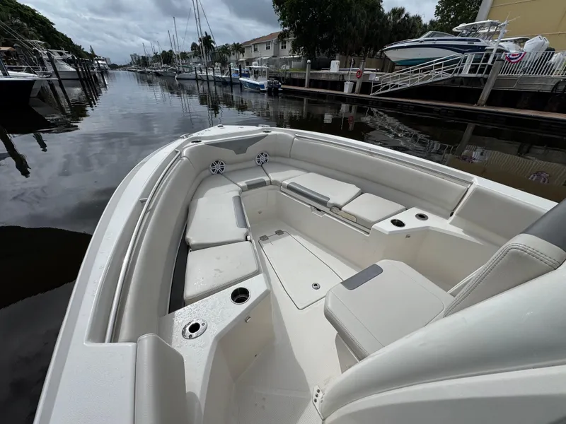 Slide: The Image of 2025 Sailfish 232 CC boat interior with cushioned seating and cup holders. - 10