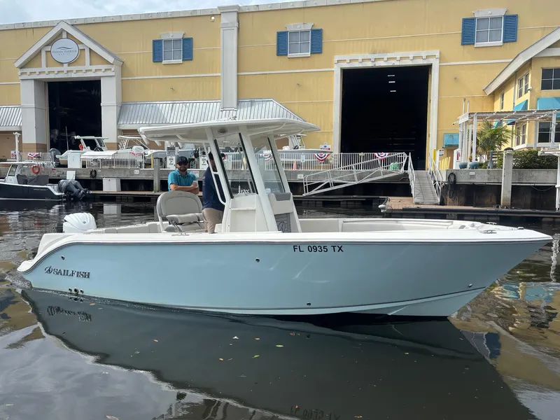 Slide: The Image of 2025 Sailfish 232 CC boat docked at marina, featuring sleek design and modern amenities. - 3