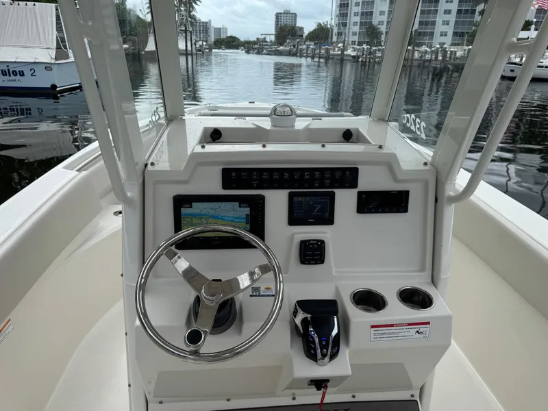 Slide: The Image of 2025 Sailfish 232 CC boat on water near dock, featuring Yamaha engine. - 5