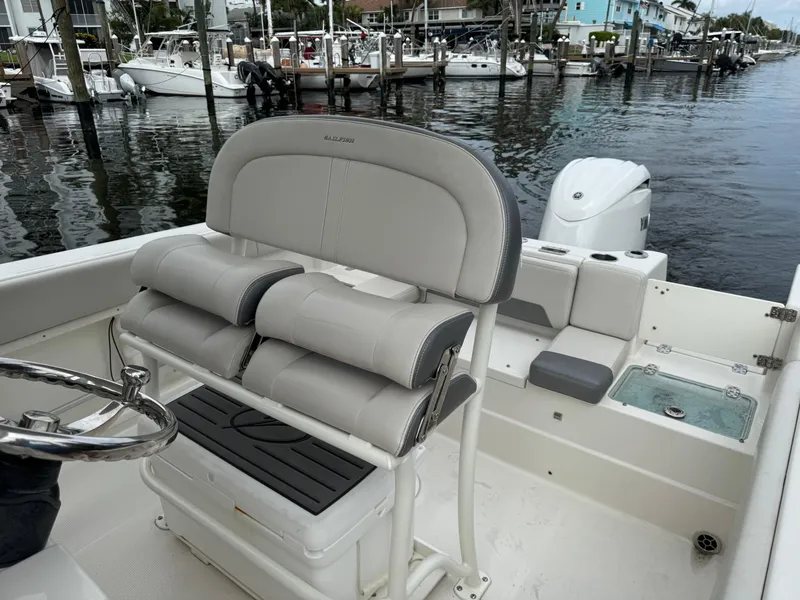 Slide: The Image of 2025 Sailfish 232 CC boat dashboard with steering wheel, navigation display, and control panel. - 7