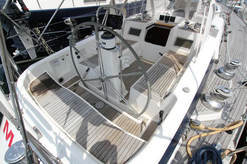 Slide: The Image of Cockpit of 1997 Nautor Swan 48 sailboat with wooden deck and steering wheel. - 14