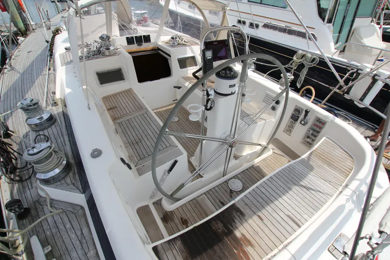 Slide: The Image of Cockpit of 1997 Nautor Swan 48 yacht with wooden deck and steering wheel. - 15