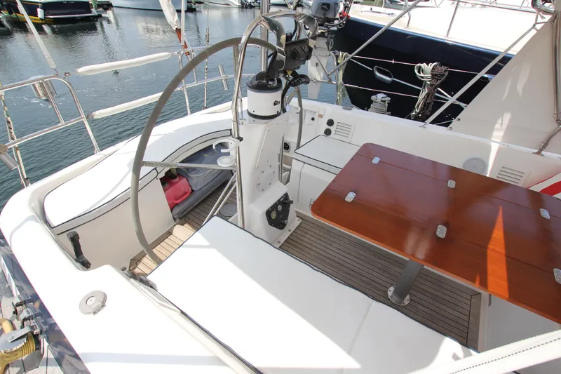 Slide: The Image of Cockpit of 1997 Nautor Swan 48 sailboat with wooden table and steering wheel. - 17