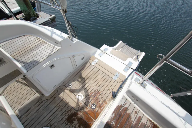 Slide: The Image of Nautor Swan 48 yacht deck, 1997 model, featuring teak flooring and water access. - 21