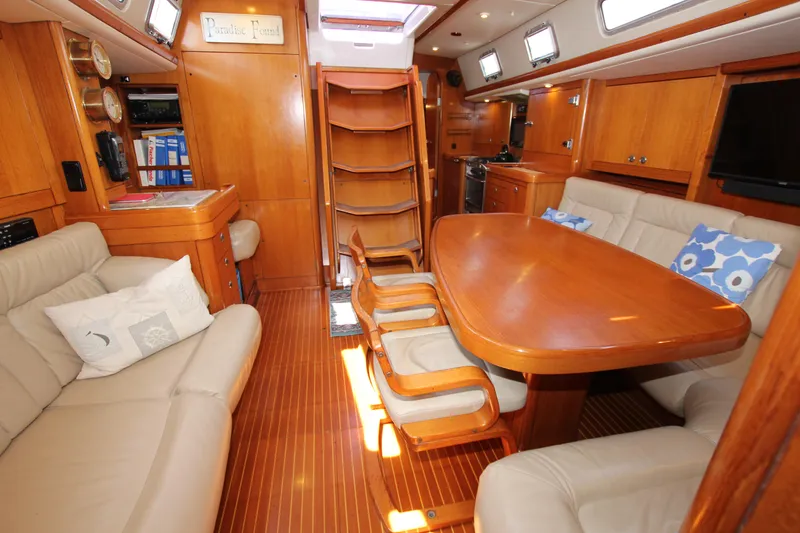 Slide: The Image of Luxurious interior of 1997 Nautor Swan 48 yacht with wooden furnishings and cozy seating. - 28