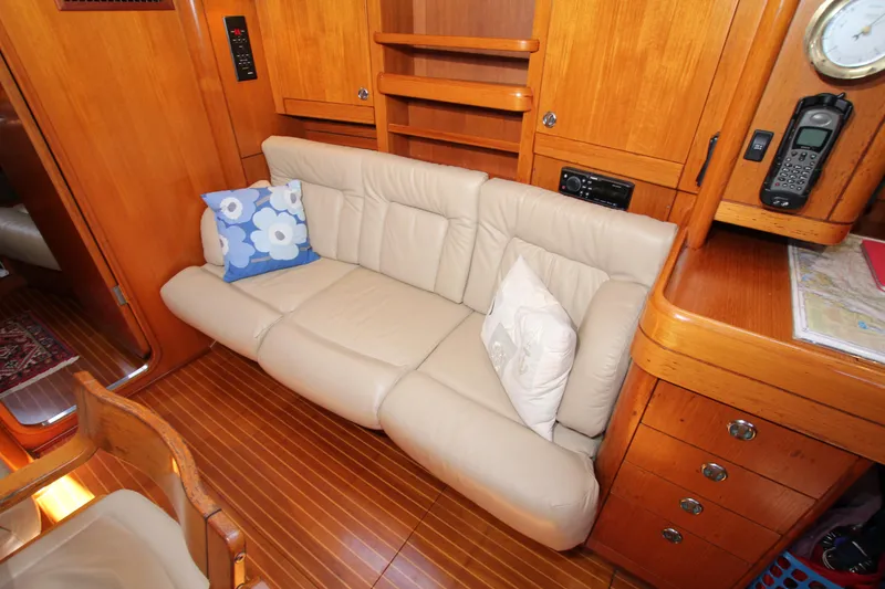 Slide: The Image of Luxurious interior of 1997 Nautor Swan 48 yacht with beige leather sofa and wooden cabinetry. - 31