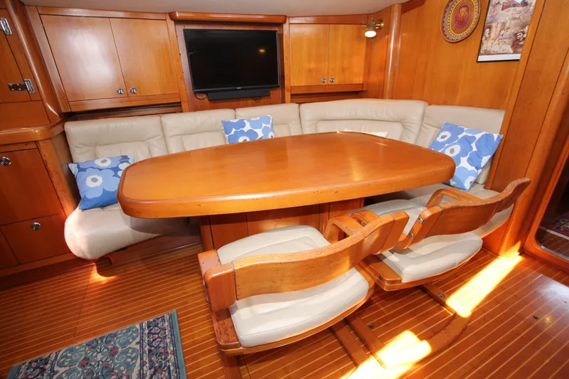 Slide: The Image of Luxurious 1997 Nautor Swan 48 yacht interior with wooden dining area and plush seating. - 32
