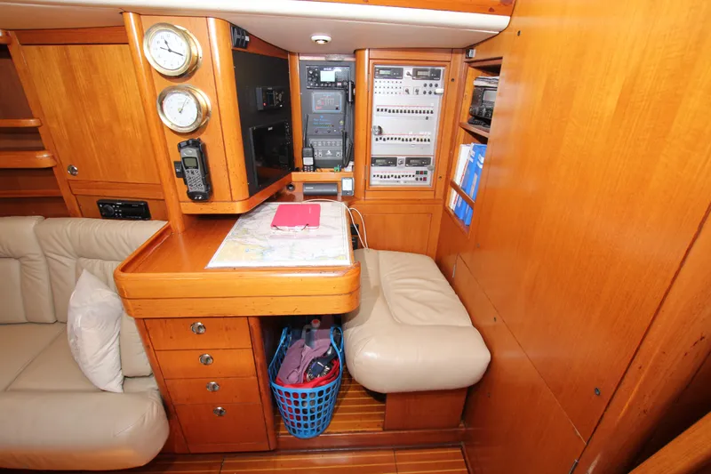 Slide: The Image of Interior of 1997 Nautor Swan 48 yacht with navigation station and wooden cabinetry. - 33