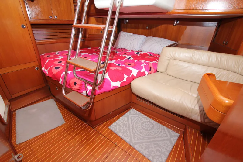 Slide: The Image of Cozy cabin interior of 1997 Nautor Swan 48 yacht with vibrant bedding and wooden finishes. - 36