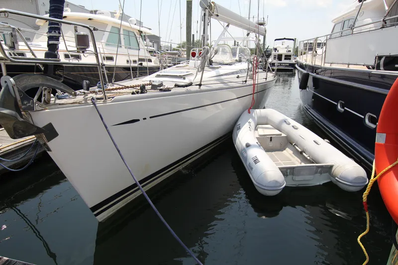 Slide: The Image of Sailboat Nautor Swan 48 (1997) docked with inflatable dinghy alongside. - 4